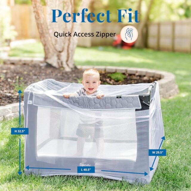 A smiling baby in a playpen outside with a Tedderfield baby mosquito net over it.