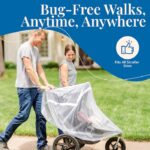 A dad and mom smiling while taking a walk with their child in a jogging stroller covered by a Tedderfield baby mosquito net.